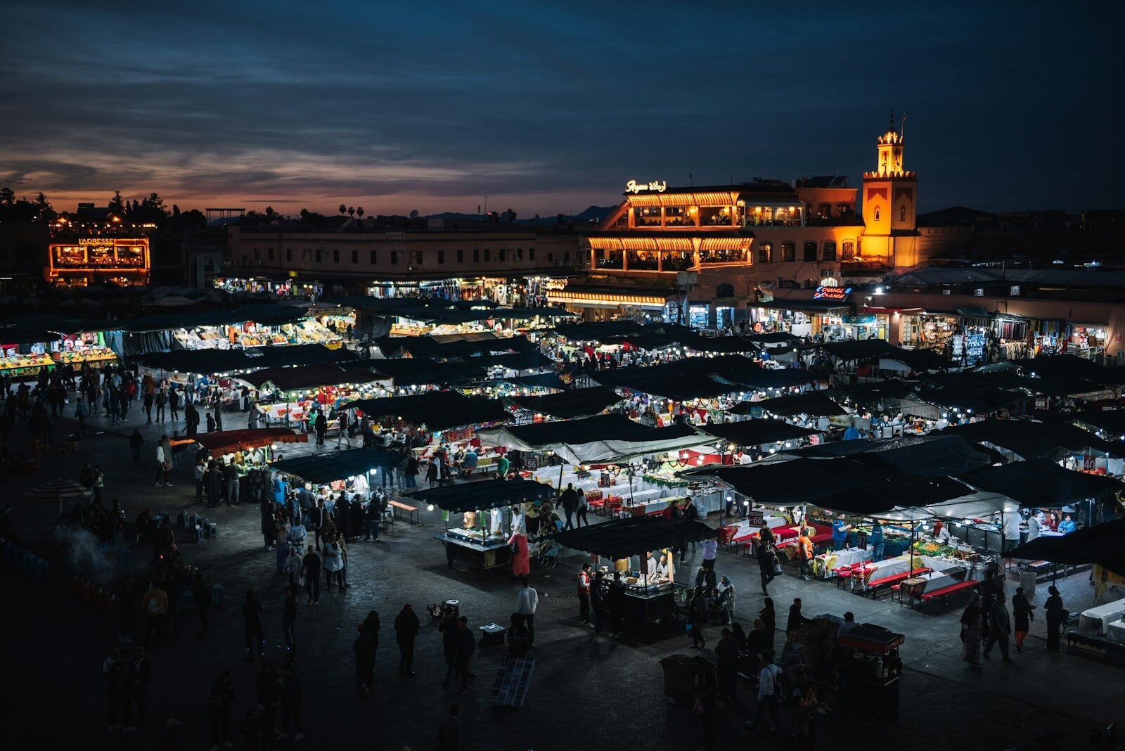 Marrakech by night with Jemaa el-Fna square lit up at sunset